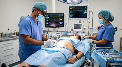 A Mexican surgeon performs a lower body lift on an American patient in a sterile operating room.