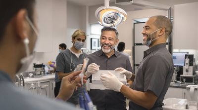 A patient admiring their new temporary bridge post-All-on-4 procedure, assisted by a diverse dental team in a Mexican clinic.
