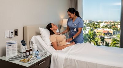 Nurse assisting patient with all-inclusive BBL recovery package.