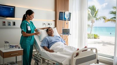 A comfortable private recovery room in a Mexican bariatric hospital with a nurse attending to a patient.