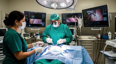 An experienced Mexican surgeon performs a laparoscopic gastric sleeve procedure in a high-tech operating room.