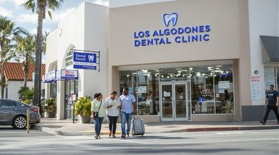 Diverse group of American patients walking toward modern dental clinic in Los Algodones border town Mexico.