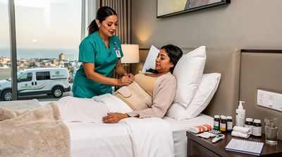 A Mexican nurse assists a recovering American patient in a Tijuana hotel room as part of an all-inclusive package.