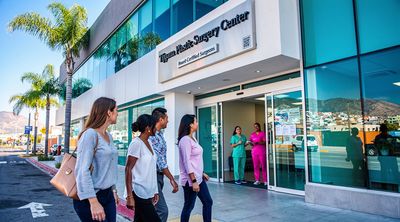 Diverse American patients enter a modern, affordable plastic surgery clinic in Tijuana.