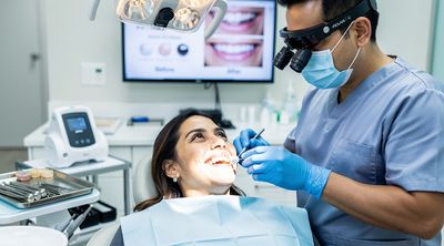 A Mexican dentist fits a zirconia crown on a patient's tooth during a cost-effective smile makeover in Tijuana.